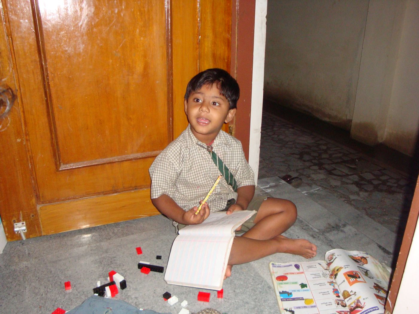 Me as a young child in school uniform with a notebook