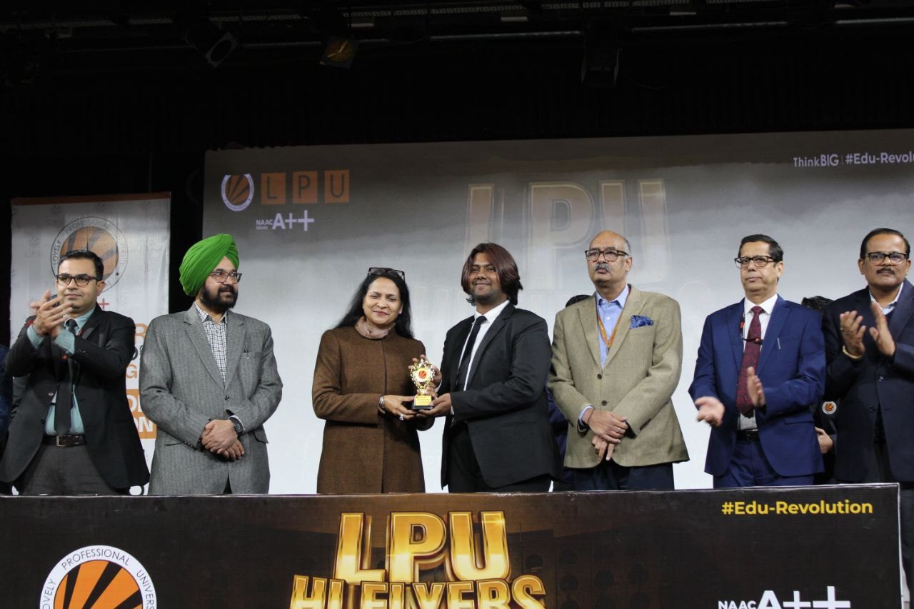 Receiving a trophy on stage at LPU Hi Flyers