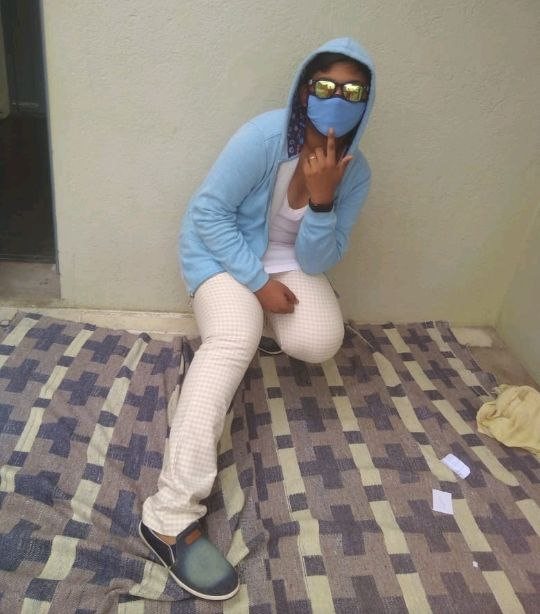 Posing in a blue hoodie, mask and mirrored sunglasses