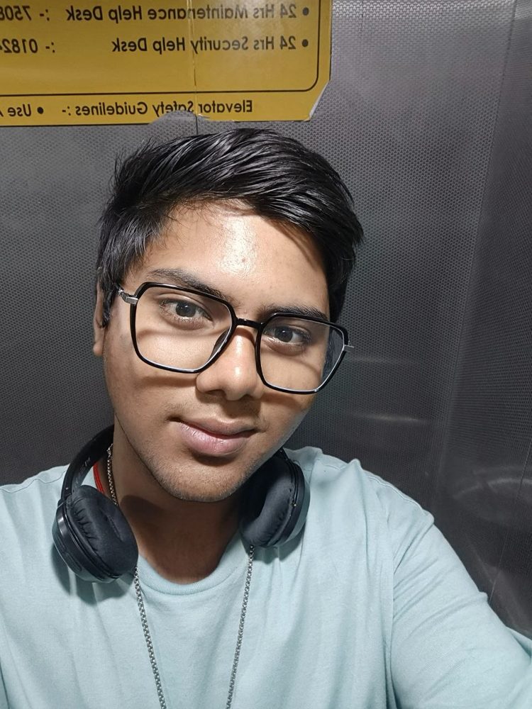 Selfie in a lift wearing glasses and headphones