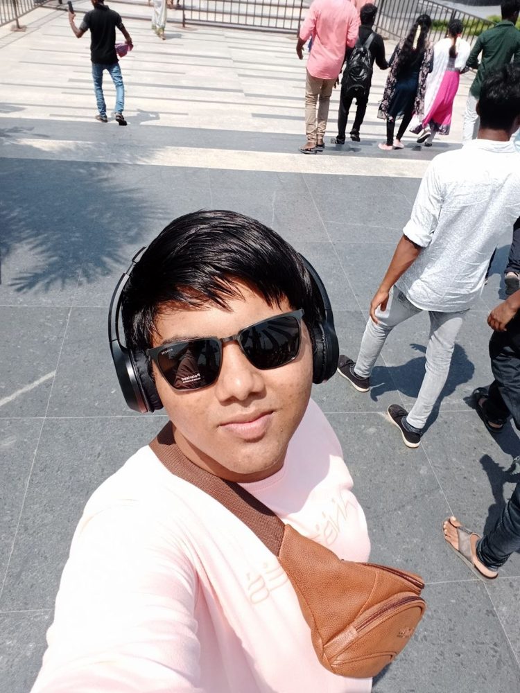 Selfie in sunglasses and headphones on a wide staircase